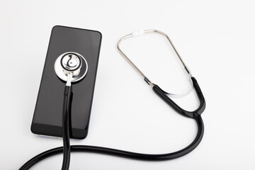 Fototapeta na wymiar Stethoscope and smartphone on white background , Checking Information Technology Security concept