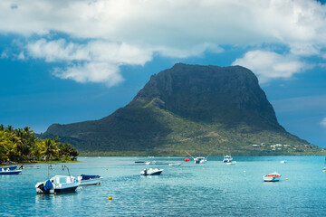 Fototapeta na wymiar View of the mountain in Le Morne Brabant and the bay with boats on the island of Mauritius in the Indian Ocean