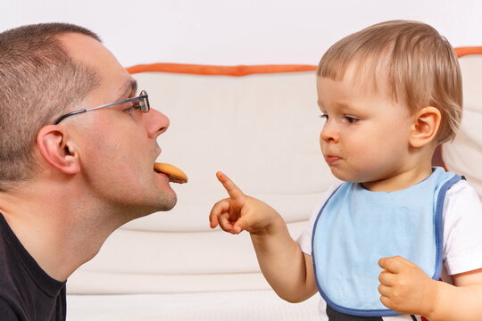 Little Son And His Father Eating Biscuit, Dessert For Kids And Parental Relations Concept