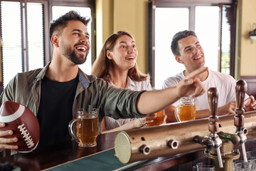 Young people placing sports bet in pub