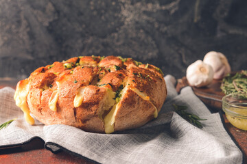 Fresh garlic bread on grunge background