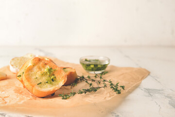 Slices of toasted bread with garlic on light background