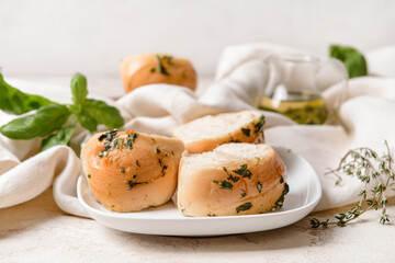 Fresh bread with garlic on light background