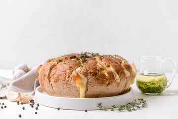 Fresh garlic bread on white background, closeup