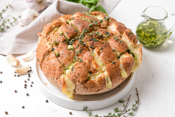 Fresh garlic bread on light background, closeup