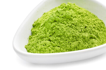 Bowl with powdered matcha tea on white background