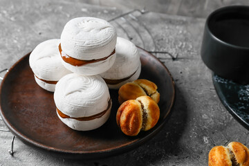 Tasty marshmallows and cookies with boiled condensed milk on grunge background