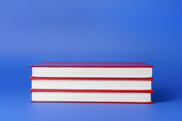 Blank books on color background