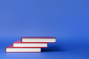 Blank books on color background