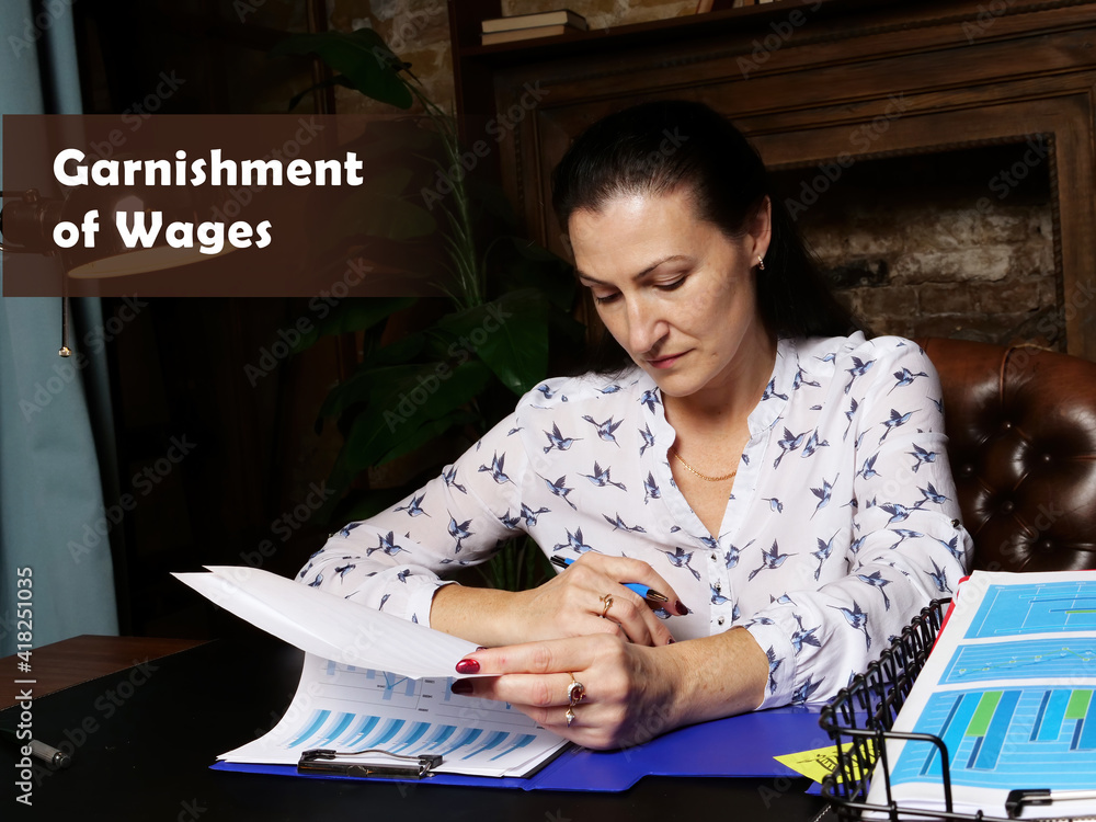 Wall mural legal concept about garnishment of wages female office workers with yellow shirt holding and writing