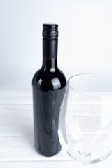 Bottle of wine and glass on white