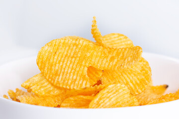 Tasty potatoes chips in bowl