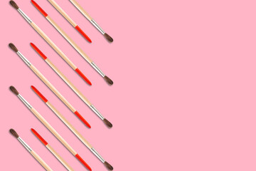 Pattern of artistic brushes for painting on a red background copy space