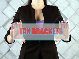 TAX BRACKETS text in futuristic screen.  Tax brackets show you the tax rate you will pay on...