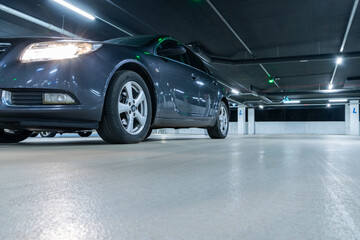 Garage interior. Car lot parking space in underground city garage. Empty road asphalt background. Large private garage.