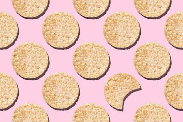 Seamless pattern Whole and bitten round gluten-free rice loaf on pink background