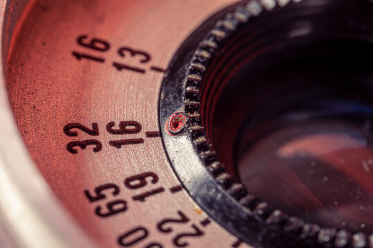 The front side of the old Soviet lens. Closeup lens with aperture scale. Low depth of field photography