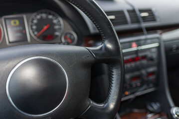 Dark car Interior. Steering wheel, dashboard. climate control, speedometer, display.From above picture.