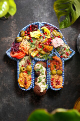 Falafel with vegetables, a colorful vegetarian dish. A healthy vegan diet.
Tasty colorful healthy dish served on a background of green plants. Suggestion to serve the dish. Culinary photography.