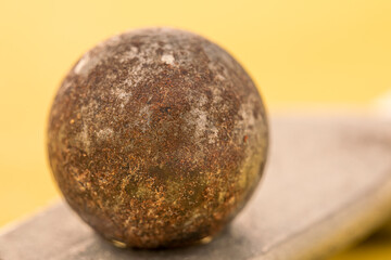 Closeup of a rusty ball bearing on a copper plate. Low depth of field photography