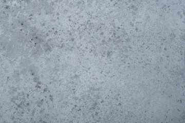 Abstract gray background with concrete texture and spots.