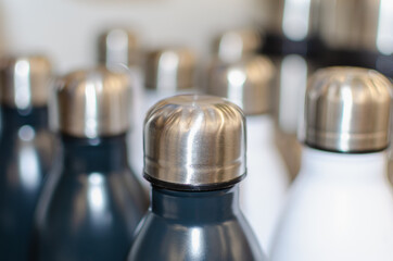 Bottles made of stainless steel, white and black.