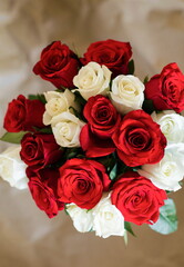 bouquet of red and white roses on craft paper