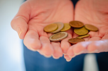 Small metal money in hand.