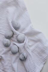Easter eggs painted with natural dye  on textured fabric.