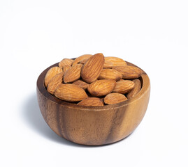 Roasted almond in wooden bowl on white background