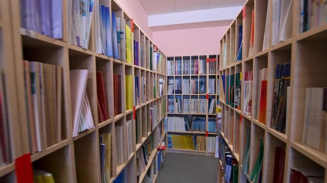 Bookshelves in university library. Interior of the library with shelves full of books