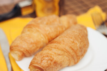 croissants in a plate on the table meal dessert for breakfast a cup of coffee