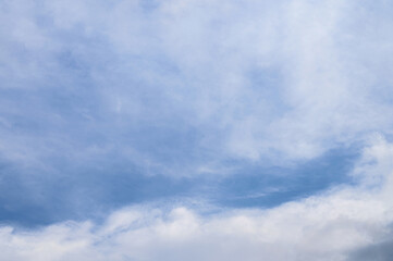 Abstract background of white fluffy clouds on a bright blue sky