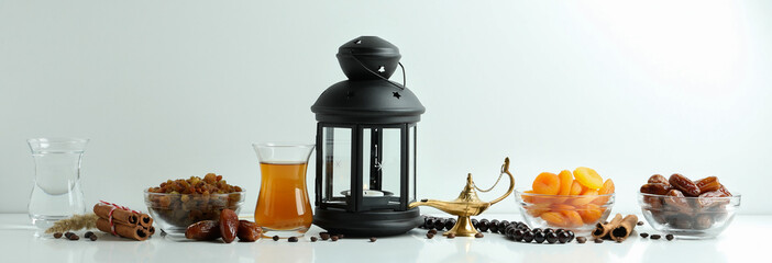 Concept of Ramadan with food and accessories on white background