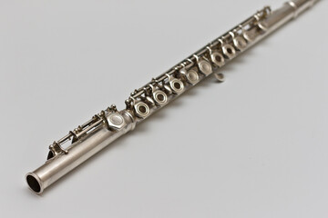 Flute lying diagonally on a white background