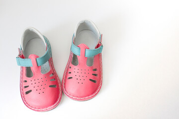 pair of baby shoes for girls on a white background