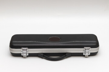 Small long black suitcase for flute on a white background