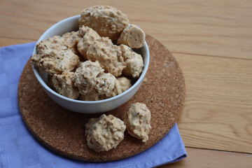 Traditional italian “Brutti ma buoni” ( Ugly but good) cookies made with hazelnut and honey in a bowl on wooden table