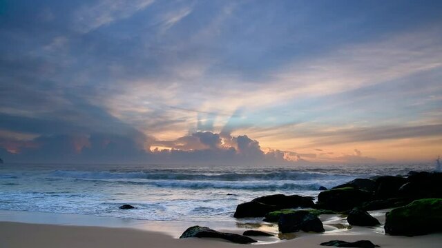 High clouds drift over a cloud bank on the horizon, a sunrise seascape from Killcare Beach on the Central Coast, NSW, Australia.