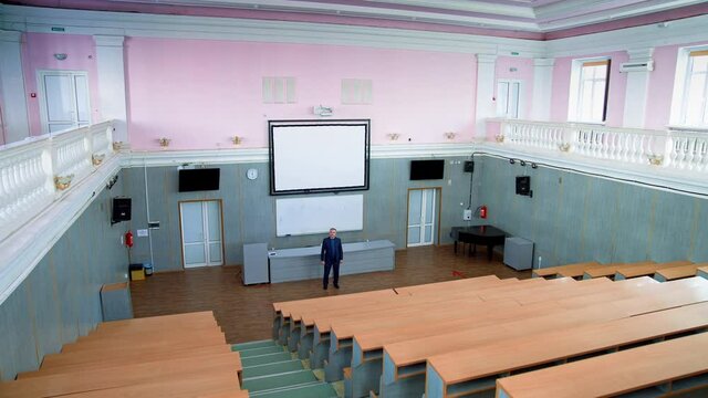 College professor in empty classroom. Professor in empty classroom during pandemic