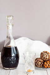 A bottle of alcoholic tincture with cedar nuts and cedar cones. Homemade, organic tincture, used...