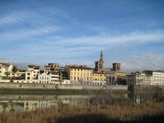 Fototapeta na wymiar View of the River Arno with historic buildings in the morning. Scenic landscape with old stone building of Gallery Uffizi. Travel to European Union. UNESCO World Heritage Site.