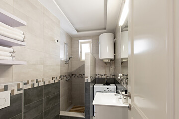 Bathroom interior with tiled walls