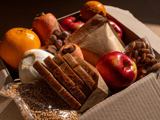 Healthy food delivery flat lay harsh shadows. Take away natural organic products package. Donation box New normal online shopping safe delivery concept. Fruits vegetables carrot apple grains bread nut