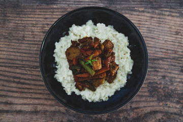 vegan thai stir fry with tofu and coconut milk rice, healthy plant-based food