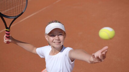 A young tennis player serves in the game. © Довидович Михаил