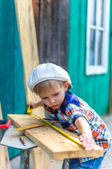 a small child helps cut otsu boards