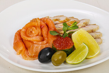 Sliced fish snack with salmon, caviar and strugeon