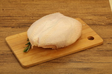 Raw whole chicken breast with skin
