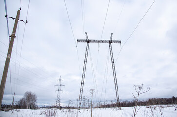 A high-voltage power line against a cloudy sky.